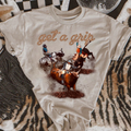 Get a Grip Rodeo Bull Riding Graphic on Gildan Softstyle Natural Shirt – Graphic Tee, Long Sleeve & Crewneck.